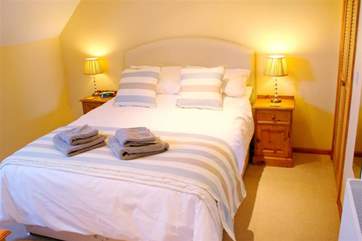 The king-size bed is the perfect place to stretch out and relax.
