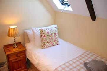 One of the two single beds in the twin room. Lie in bed and look at the stars if you wish.
