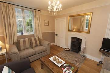 The sitting-room has a woodburning stove.