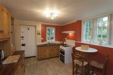 The kitchen has a door to the gardens.