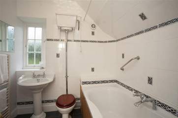 The bathroom features a mix of old and new fixtures; all the luxury of modern conveniences with an antique feel.