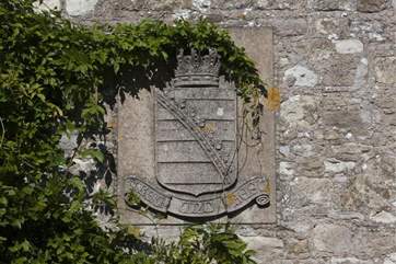A coat of arms on the outside of the building.