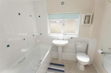 The clean white bathroom suite.