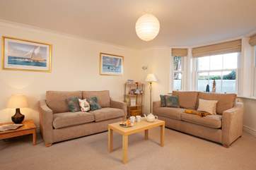 The sitting room is spacious and light, with plenty of room for relaxing or entertaiining.