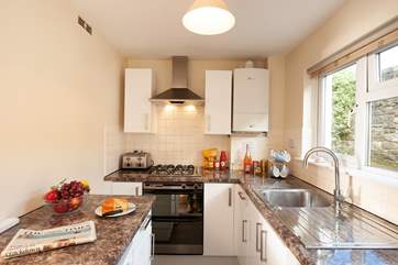 The modern, galley kitchen is bright and well-equipped with everything you are likely to need on your Island getaway.