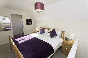 The master bedroom on the first floor has an en suite bathroom.