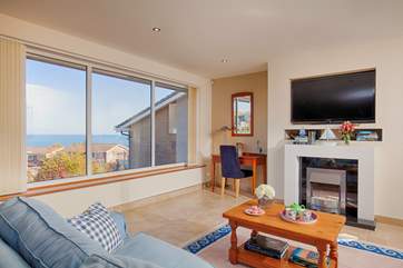 The sitting room just beyond the kitchen benefits from expansive sea views.