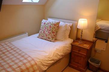 The twin room has beds in an 'L' shape.