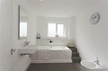 Luxury family bathroom with a bath to step down into.