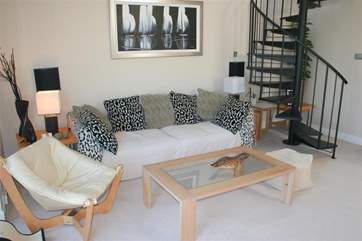 The living area on the first floor has soft seating for five.