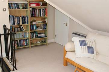 The mezzanine level has a study/office area, additional soft seating and a bookcase.