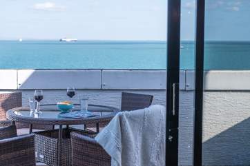 Relax on the stunning balcony and watch the ships sail by