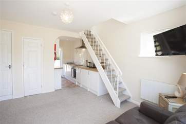 The stairs lead to the first floor, where there is a king-size bed and en suite bathroom.