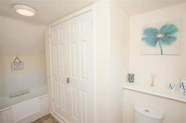 The en suite bathroom has storage and a full bath.
