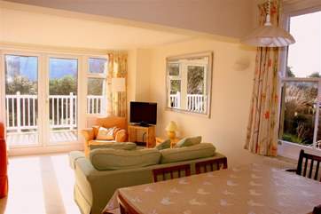 The living room is open plan, and the dining-area is a lovely sunny spot for meal times