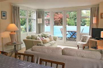 3 Astra House boasts a lovely light, sunny living room with doors out to a decked balcony