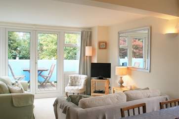 The living room is open plan, and the dining-area is a lovely sunny spot for meal times