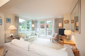 3 Astra House boasts a lovely light, sunny living room with doors out to a decked balcony