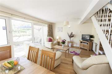 Large sunny, open plan living room and dining-area with doors out to the balcony