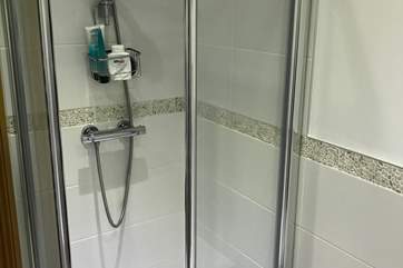 There is a shower cubical in the bathroom, along with a seprate bath.
