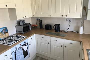 The bright modern kitchen is well-equipped.