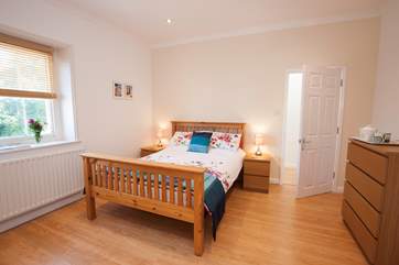 The master bedroom has plenty of space and is simply decorated, making it feel calm and relaxing