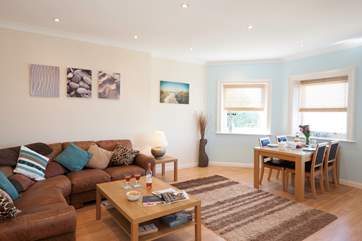 The open plan living room/dining room is a modern and well decorated space boasting spectacular views, plenty of light and a calm feel throughout