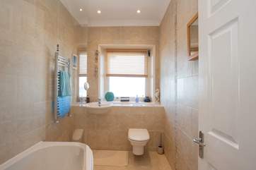 With a fitted shower over the bath, there is the choice of a quick morning shower, or a long evening soak in a bubble bath
