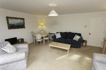 Living room with soft seating and additional dining-area
