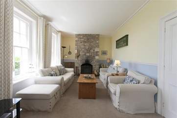 Large living room with open fire and windows offering superb views