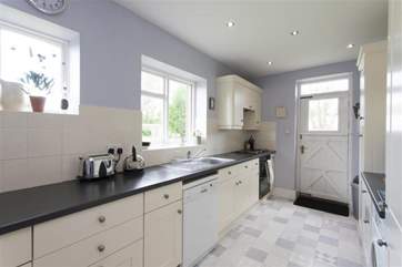 Large fully equipped kitchen with door out to large lawned garden