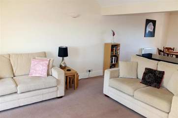 The living area is open plan with the kitchen and dining-area.