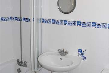 Family bathroom with shower over the bath.