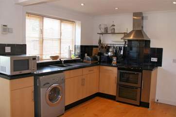 The kitchen overlooks the communal couryard and parking-area