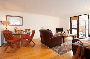 The open plan living, dining-room and kitchen open up to a fully enclosed patio.