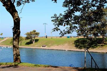 The lake is full of swans and, at the far end to the left, there is a swimming pool with retractable roof for the summer