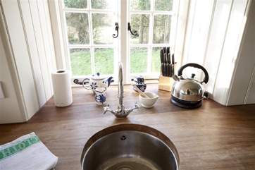 The kitchen is traditional rustic cottage in style