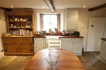 The country style kitchen is open plan with the dining-area