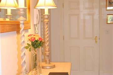 The hallway inside this ground floor apartment is a lovely open space with doors connecting to all other rooms