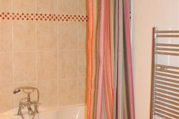 The family bathroom has a shower over the bath