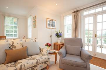 The patio doors lead out from the sitting room onto the terrace overlooking the pool.