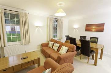 The sitting-room is open plan with the dining-room and kitchen