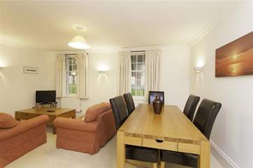 The dining table is spacious and four people can sit more than comfortably around it