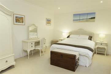 The master bedroom has a king-size bed and an en suite bathroom with walk in shower