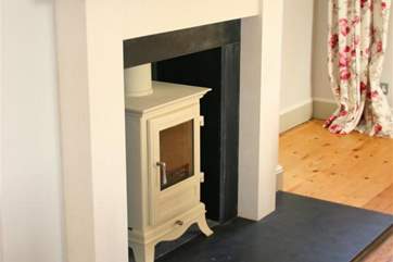 The pretty woodburning stove in the dining-room.