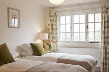 Twin bedroom also boasting tranquil views across the lake