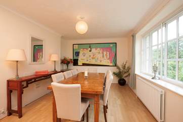 The lovely dining room has a large dining-table with seating for eight