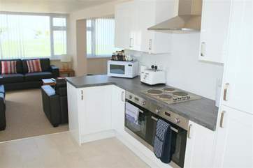 A modern kitchen leads through to the lounge and has a doorway to the outside picnic area