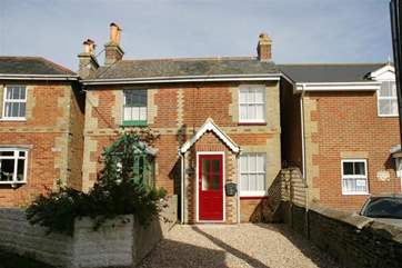 The semi-detached property has a red door.
