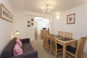 The dining area is located conveniently close to the kitchen.
